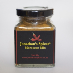A square shaped glass jar with a black, red and yellow label containing Jonathan's Spices moroccan mix