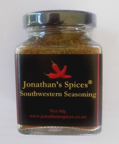A square shaped glass jar with a black, red and yellow label containing Jonathan's Spices southwestern seasoning